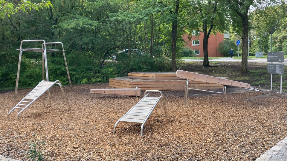 Ett utegym med träningsredskap i trä och metall.